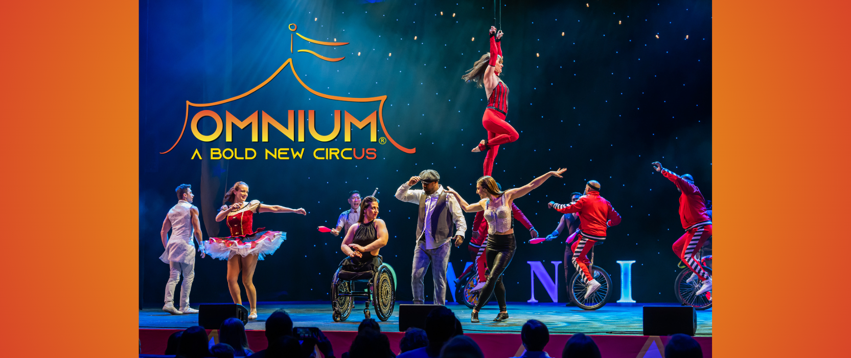 blue lit stage crowded with circus acrobatics. text reads omnium circus